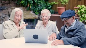 Senior people waving during a video call in a geriatric