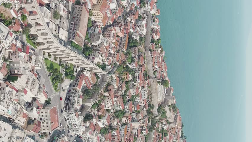 Vertical video. Kavala, Greece. Kavala Fortress and Aqueduct. Historic city center. Summer, Aerial View, Departure of the camera