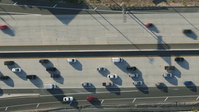 Aerial view of cars moving on Calabasas 101 highway, Los Angeles, USA. Top shot of vehicles driving to The Commons shopping center. Overhead view of automobiles in traffic jam on freeway, 4k footage