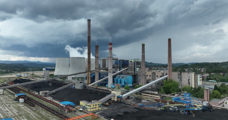 Aerial drone footage of a large coal power plant station with cooling towers chimney and boiler house in an air pollution or carbon footprint concept Royalty-Free Stock Footage #3394339719