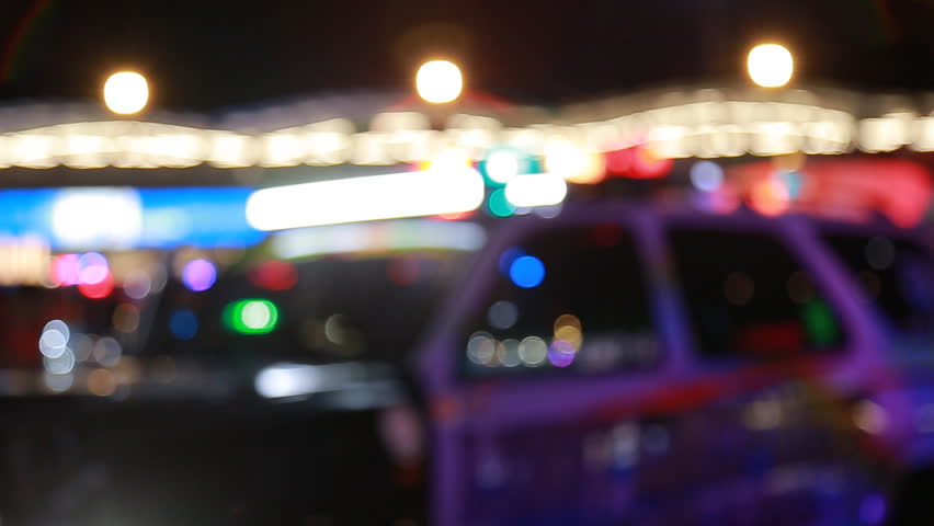 Blurred lights of Emergency vehicle Ambulance standing in night traffic at a motor vehicle accident. | Shutterstock HD Video #33944125
