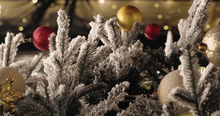 Woman hands decorating Christmas tree with ornament. New Year