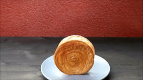 Footage of Hand Topping Delectable Supreme Croissant with Chocolate Ganache and Chopped Nuts - Powered by Shutterstock - Get 15% off with code: PIKWIZARD15