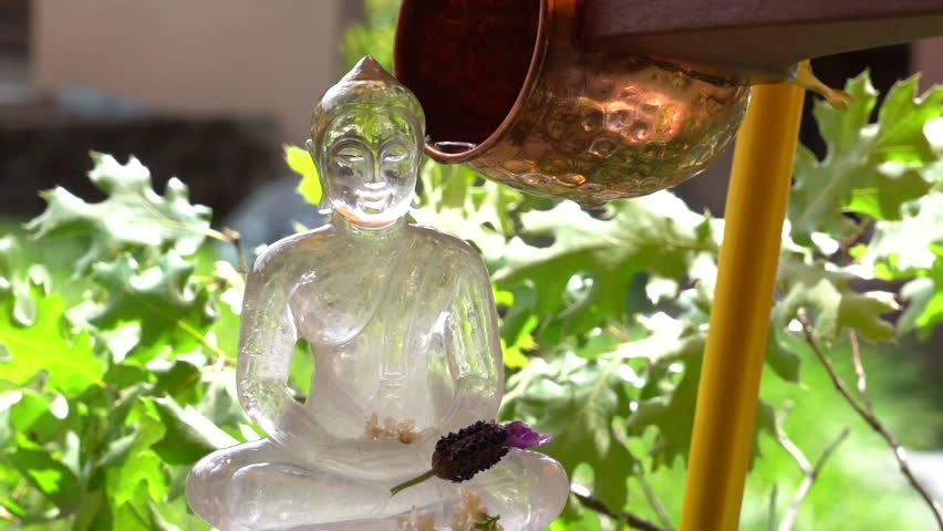 Pouring water on a Buddha image made of glass on Songkran Day at Abhayagiri buddhist Monastery. CA, USA. Royalty-Free Stock Footage #3394595913