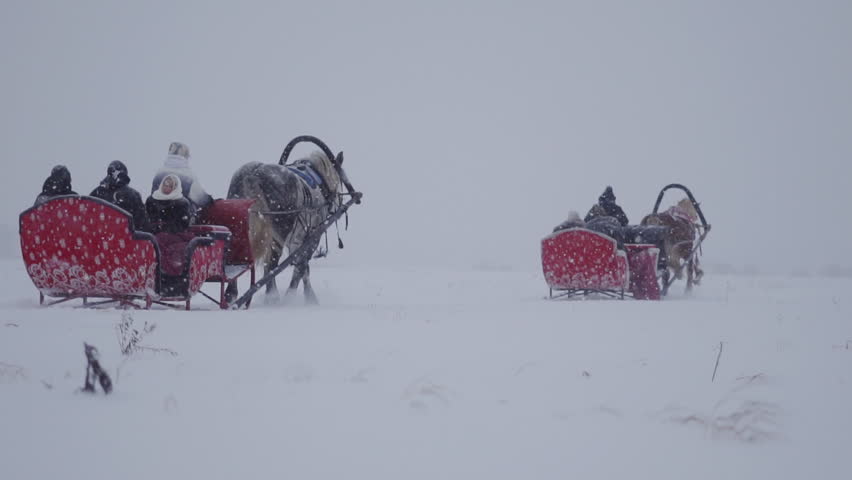 horses galloping through the snow with a sleigh
