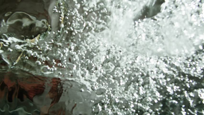 Bubbles in the water close-up maro. Boiling water texture. 