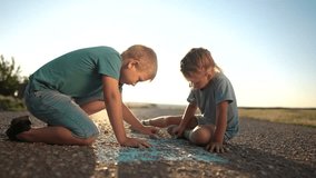 girl and boy are drawing house on the asphalt. happy family kid concept. girl boy sit on asphalt during the day and draw home big with blue chalk. girl boy draw dream with chalk on the asphalt - Powered by Shutterstock - Get 15% off with code: PIKWIZARD15