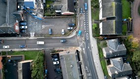 4k aerial view of traffic passing through a residential area of Ipswich, Suffolk, UK