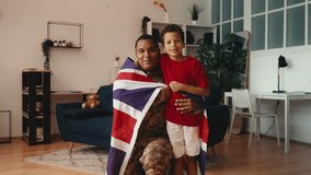 Portrait of proud soldier father and little son wrapped in United Kingdom flag - Powered by Shutterstock - Get 15% off with code: PIKWIZARD15