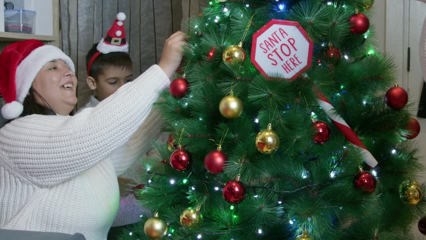 Family decorating the christmas tree. Quality family time during christmas holidays. High quality 4k footage