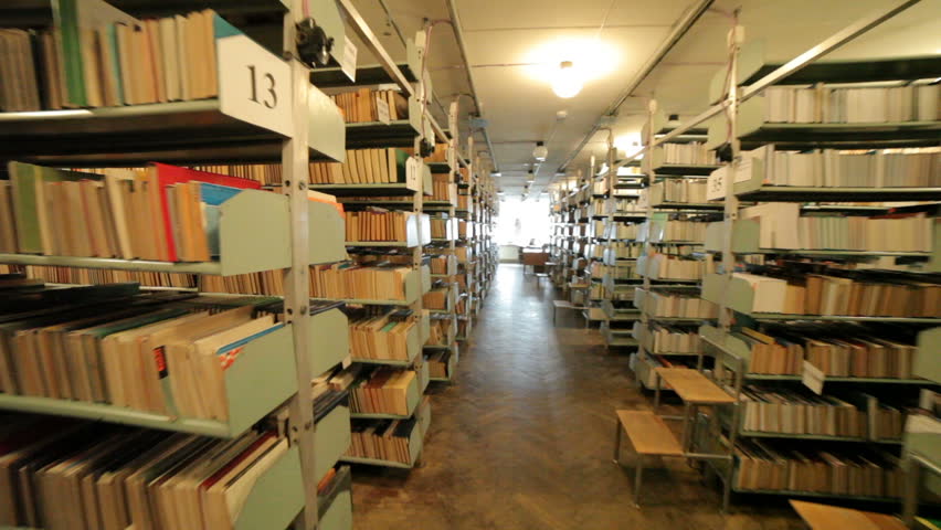 There is a crazy woman in the library, a candle is burning in her hands.