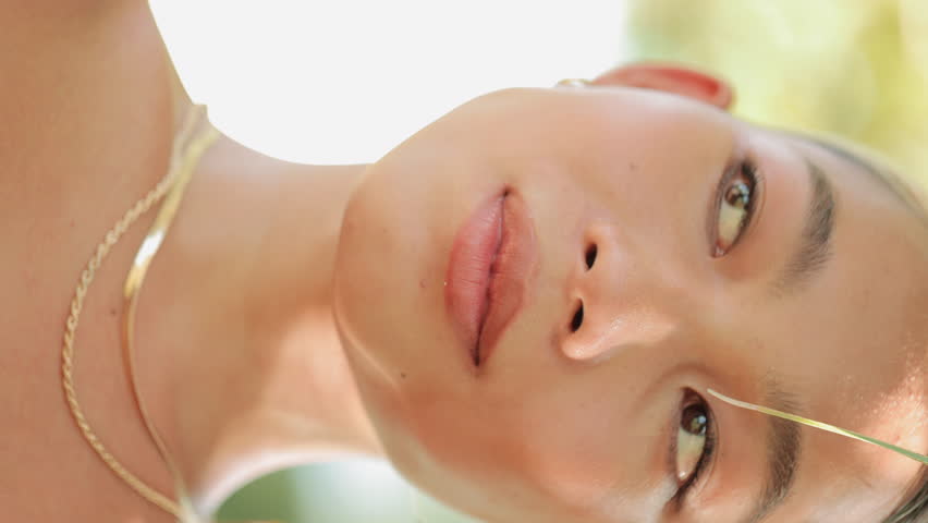 Vertical Video. Charming Young Asian Fashion Model Posing Outside, Wearing Jewelry. Cute Smiling Chinese Lady Outdoors. Jewelry Advertising. People and Advertising Concept