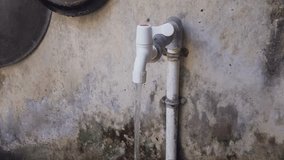 Flowing water from plastic water tap, outdoor sanitation to clean dirty kitchen utensils