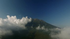 Agung volcano with clouds. Drone view of Bali. 