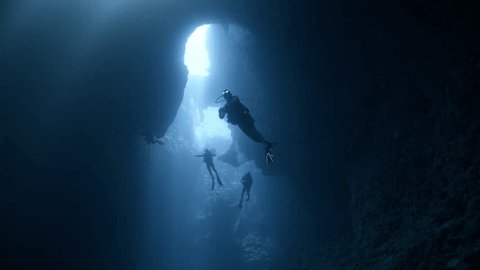 SCUBA Divers explore a large underwater cavern 스톡 비디오