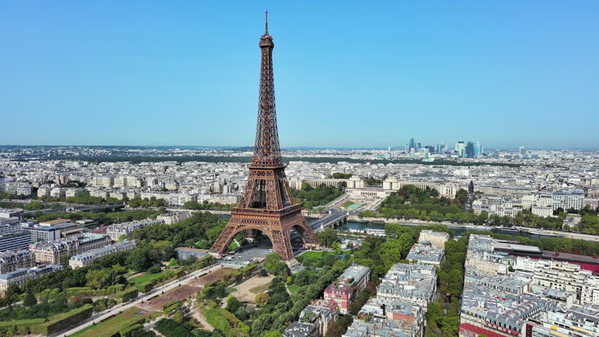 Aerial View of Paris, France: Iconic Landmark Eiffel Tower and Champ de Mars, skyscrape skyline of La Défense in Background, Clear Blue Sky Royalty-Free Stock Footage #3395177077