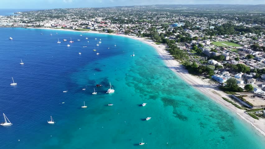 Aerial landscape video view of shoreline and bay area along Carlisle Bay (with turquoise water)  at Bridgetown,  overflying Pebbles Beach, Brownes Beach and Bayshore Beach at Barbados,  video footage  Royalty-Free Stock Footage #3395203051