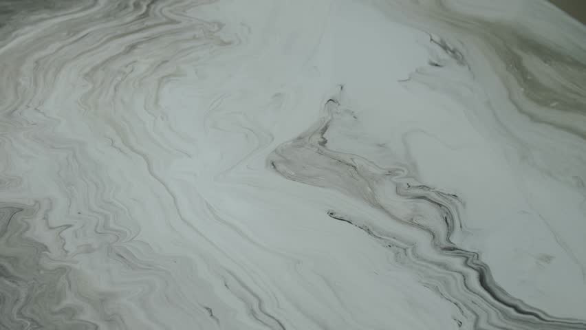 Close-up marble surface of the tabletop in the luxury kitchen. Top view of white marble texture and zoom in camera, slow motion.