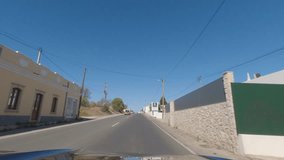 First person view, FPV, from dashcam of car driving along the Algarve Coast in Portugal, driving on the highway towards Faro. Road trip video in POV, with blue sky