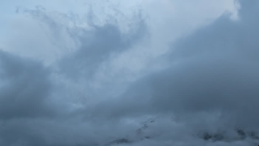 4k zoom in timelapse of storm clouds moving over snowy mountains in Keylong, India. Bad weather in winter. Winter mountains landscape. Snow storm on snowy peaks of Himalayas. Ken burn timelapse. 