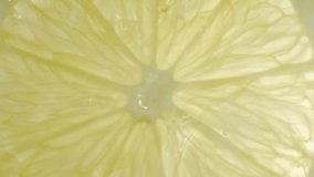 Drops of liquid falling on fresh sliced lemon pieces in slow motion. Beautiful ice water splash on lemon slices in macro. Vitamin C or serum acid in cosmetic product - Powered by Shutterstock - Get 15% off with code: PIKWIZARD15