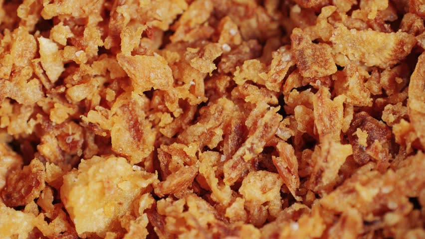 Traditional fried crispy onions backed in flour close-up macro. Dried onion topping. Fast food. Snacks