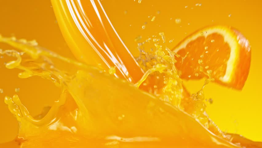 Orange slices splashing into juice, macro shot. Macro background. Filmed on a high-speed cinema camera at 1000 fps.