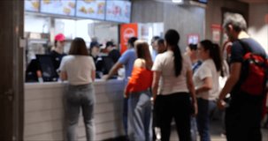 A Group of People Waiting in Line at a Fast Food Restaurant. Blurred background 4K video.
