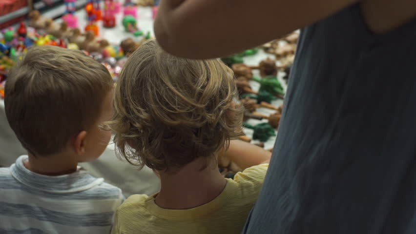 Slowmotion shot of Two little boys on a night asian market