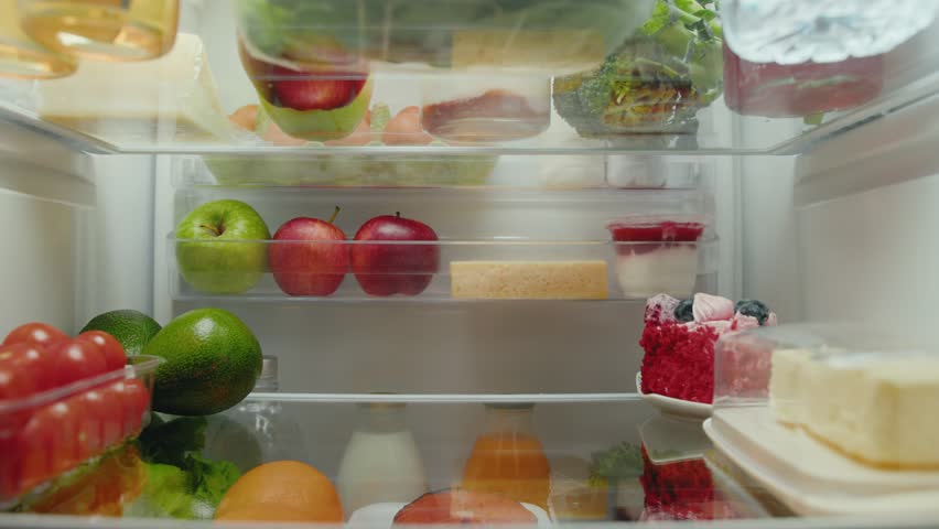 Young Woman Opens Fridge with Diet Food of Fruits and Vegetables and Taking Sweet Dessert to Eat. Kitchen Refrigerator of Healthy Lady Getting Meal with Cake. Freezer Filled with Convenience Purchase
