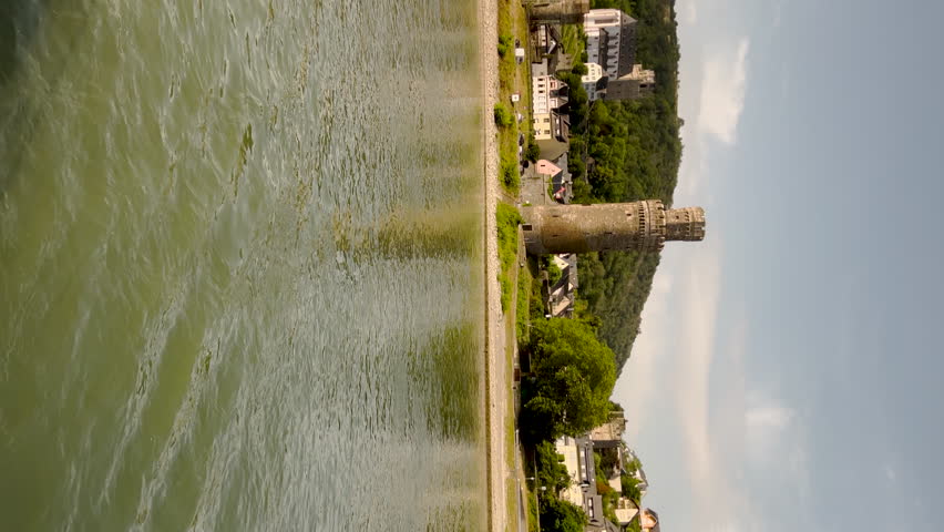 Oberwesel, Germany. Rhine Gorge (Middle Rhine). Cultural Medieval German Town as Viewed from the Rhine River. Views of charming European style architecture and agricultural fields on the sloping land.
