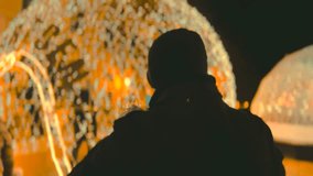 Man silhouette put on hat at winter night with cozy spherical city lights bokeh - Powered by Shutterstock - Get 15% off with code: PIKWIZARD15