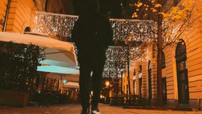 Man walking away in cozy lights at winter in the city 4k - Powered by Shutterstock - Get 15% off with code: PIKWIZARD15