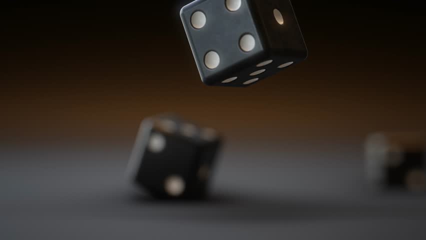 A bunch of thrown dices rolling on the table against dark background.