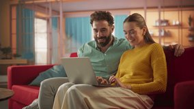 Portrait of Young Couple Using Laptop Computer While Sitting on a Couch at Home. Engaged Couple Doing Online Shopping for their Wedding Preparations, Discussing Different Options Using Technology - Powered by Shutterstock - Get 15% off with code: PIKWIZARD15
