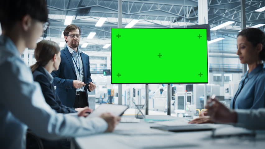 Electronics Factory Office Meeting: Caucasian Male CEO Presenting Innovative High-Tech Device On TV With Green Screen Chromakey. Diverse Engineers And Technicians Listening, Planning Production. Royalty-Free Stock Footage #3395933941