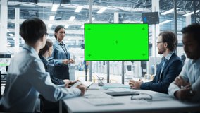 Electronics Factory Office Meeting: Hispanic Female Project Manager Presenting Innovative High-Tech Device On TV With Green Screen Chromakey. Diverse Engineers And Technicians Listening, Taking Notes. - Powered by Shutterstock - Get 15% off with code: PIKWIZARD15