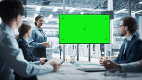 Electronics Factory Office Meeting: Hispanic Female CEO Presenting Innovative High-Tech Device On TV With Green Screen Chromakey. Diverse Engineers And Technicians Listening, Planning Production. - Powered by Shutterstock - Get 15% off with code: PIKWIZARD15