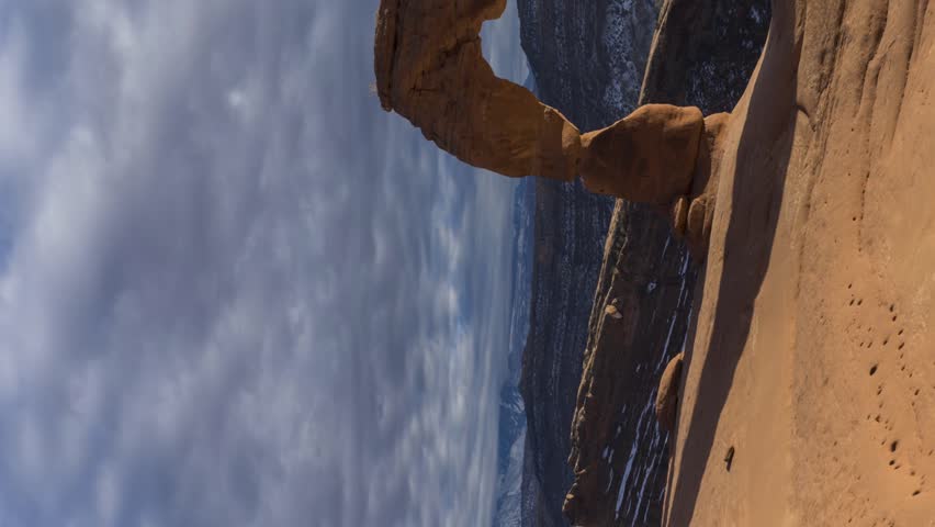 Delicate Arch at Sunset. Arches National Park, Utah, USA. Motion Time Lapse. Vertical Video