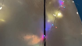 Surfboard decorated with Christmas ornament and Santa hat. Shimmering light on alternative Christmas tree of surfer. Surf style New Year decor. Film grain pixel texture. Soft focus. Live camera. Blur - Powered by Shutterstock - Get 15% off with code: PIKWIZARD15