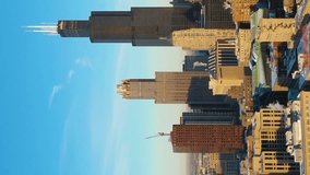 Urban Cityscape of Chicago Loop at Sunrise in Frosty Winter Morning. Golden Hour. Aerial View. United States of America. Drone Flies Sideways. Vertical Video