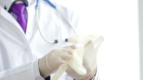 Doctor wearing rubber gloves. 4K UltraHD video