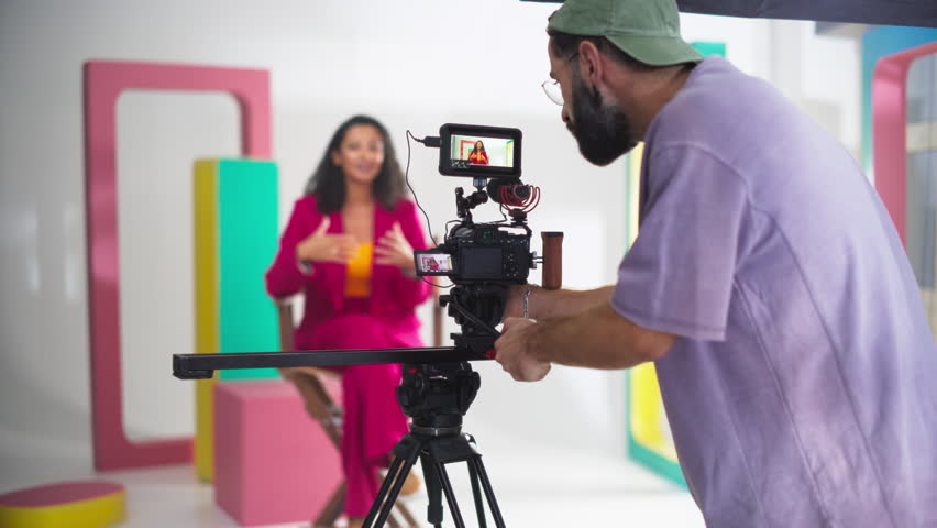 Slow Motion Footage of Behind the Scenes of Creating a Commercial: Young Film Industry Professionals Working on Set to Make Video Content for Marketing. Film Crew Collaborating on a Cinematic Project