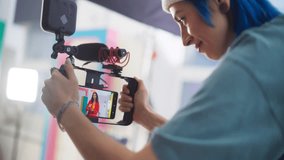 Young Female Content Creator Working with her Cinematographer to Film a Video in Bright Minimalistic Set. New Generation of Filmmakers Using Smartphone to Shoot Budget-Friendly, High-Quality Project - Powered by Shutterstock - Get 15% off with code: PIKWIZARD15