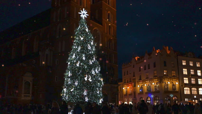 Stylish xmas golden illumination and Christmas tree. Krakow, Poland, Main Square and Cloth Hall in the winter season, during Christmas fairs decorated with Christmas tree. 