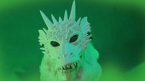 Green Dragon rotating head, with different color glowing eyes, floating on light green background in fog, 2024 zodiac symbol. Lunar new year celebration. - Powered by Shutterstock - Get 15% off with code: PIKWIZARD15