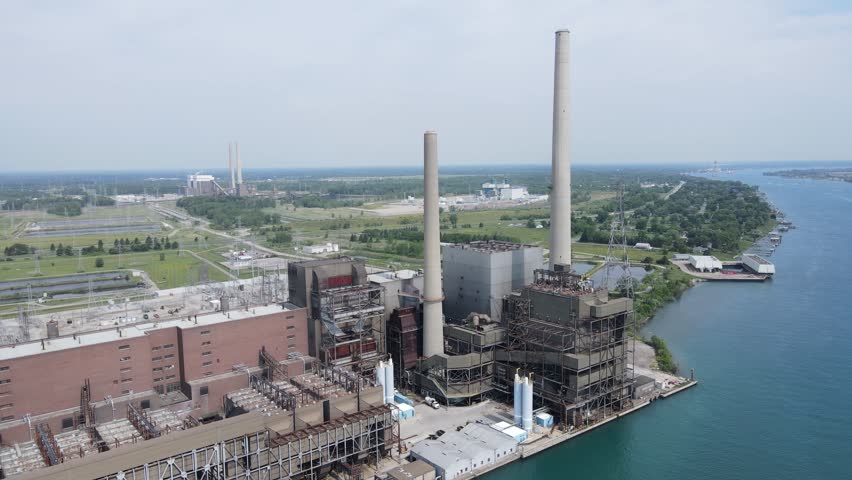 DTE St. Clair coal-fired power plant with coal piles in background, aerial view