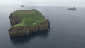 An isolated and deserted island in Iceland with a house (cottage).