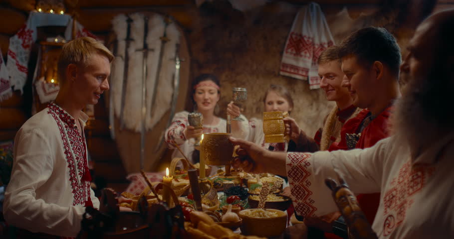 culture and traditions of Slavs, people in Ukrainian historical suites dining in house, 4K, Prores