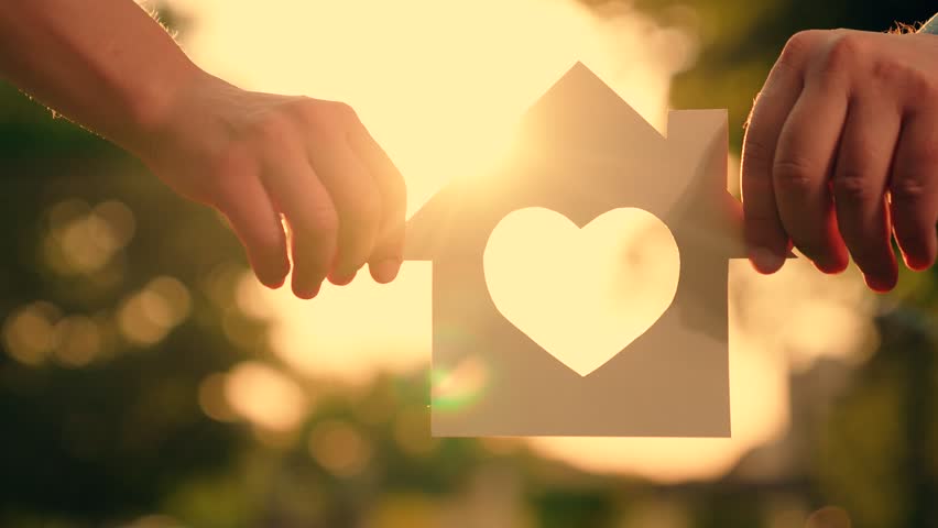 Symbol of home, happiness. Concept of building house for family, child. Real estate insurance. Paper house in hands at sunset in park, sun is shining through window, family dreams of buying house. Royalty-Free Stock Footage #3396286445